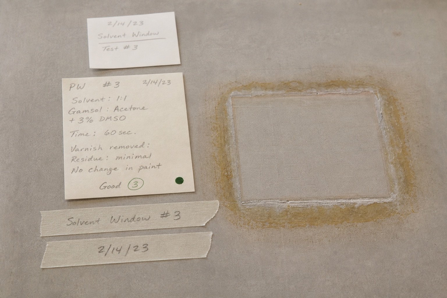 Note slips and masking-tape labels beside a cleaned solvent window
